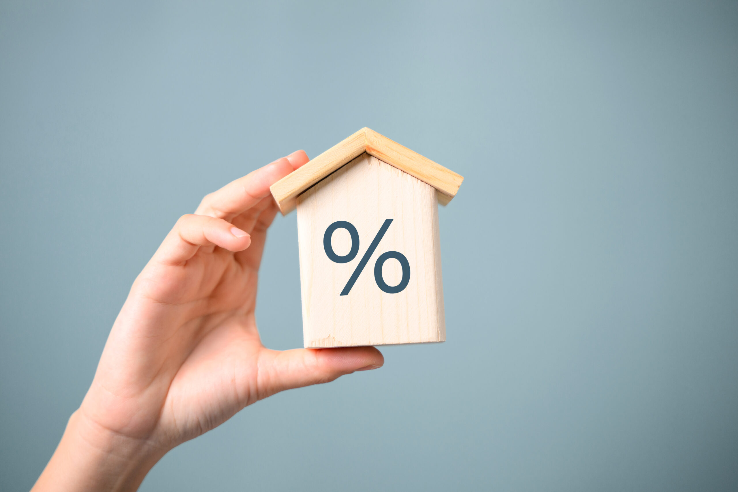 interest percent symbol icons on wooden house cube, home real estate. High quality photo