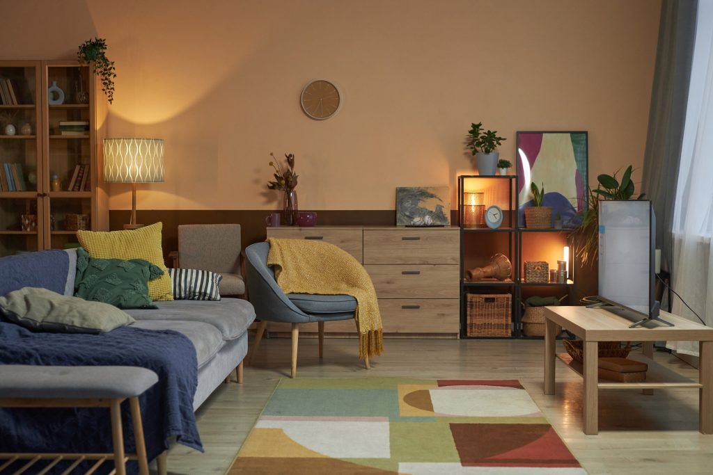 Background image of cozy living room interior with low lighting and colorful decor copy space